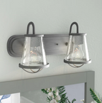 Wall-mounted light fixture with two glass shades on a neutral background