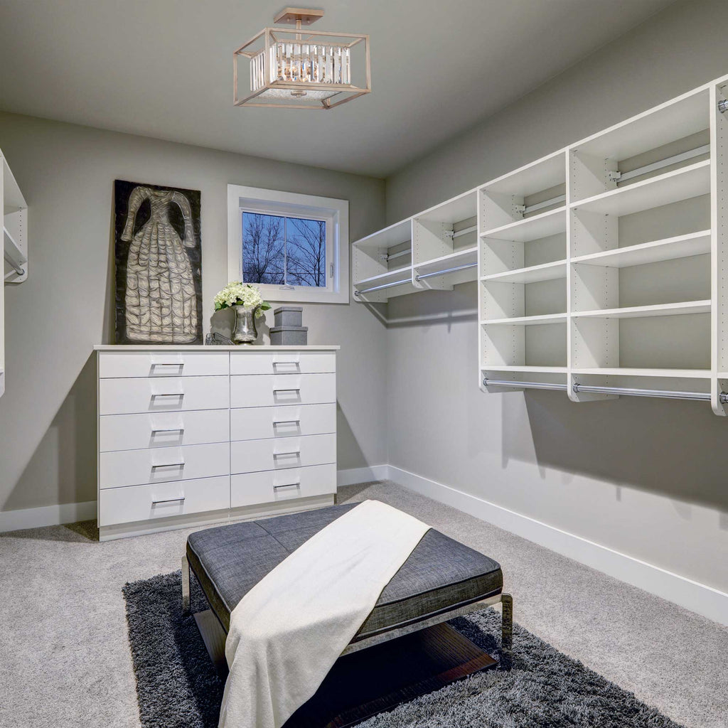 Modern bedroom with white dresser, shelves, and gray ottoman.
