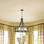 Dining room with a table and chairs, yellow curtains, and a chandelier.