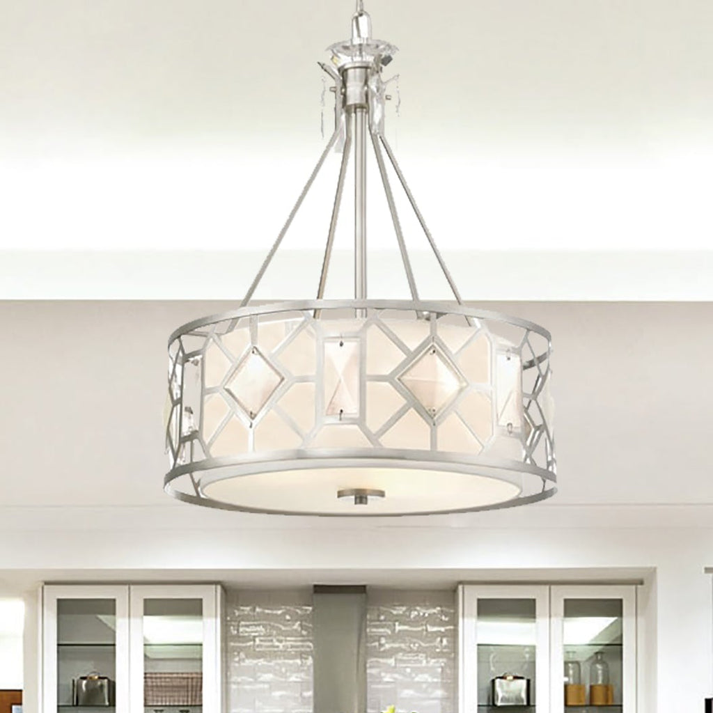 Modern kitchen with dining table and chairs, featuring a chandelier and stainless steel appliances.