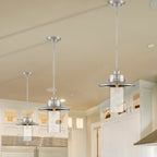 Modern kitchen with pendant lights and stainless steel appliances.
