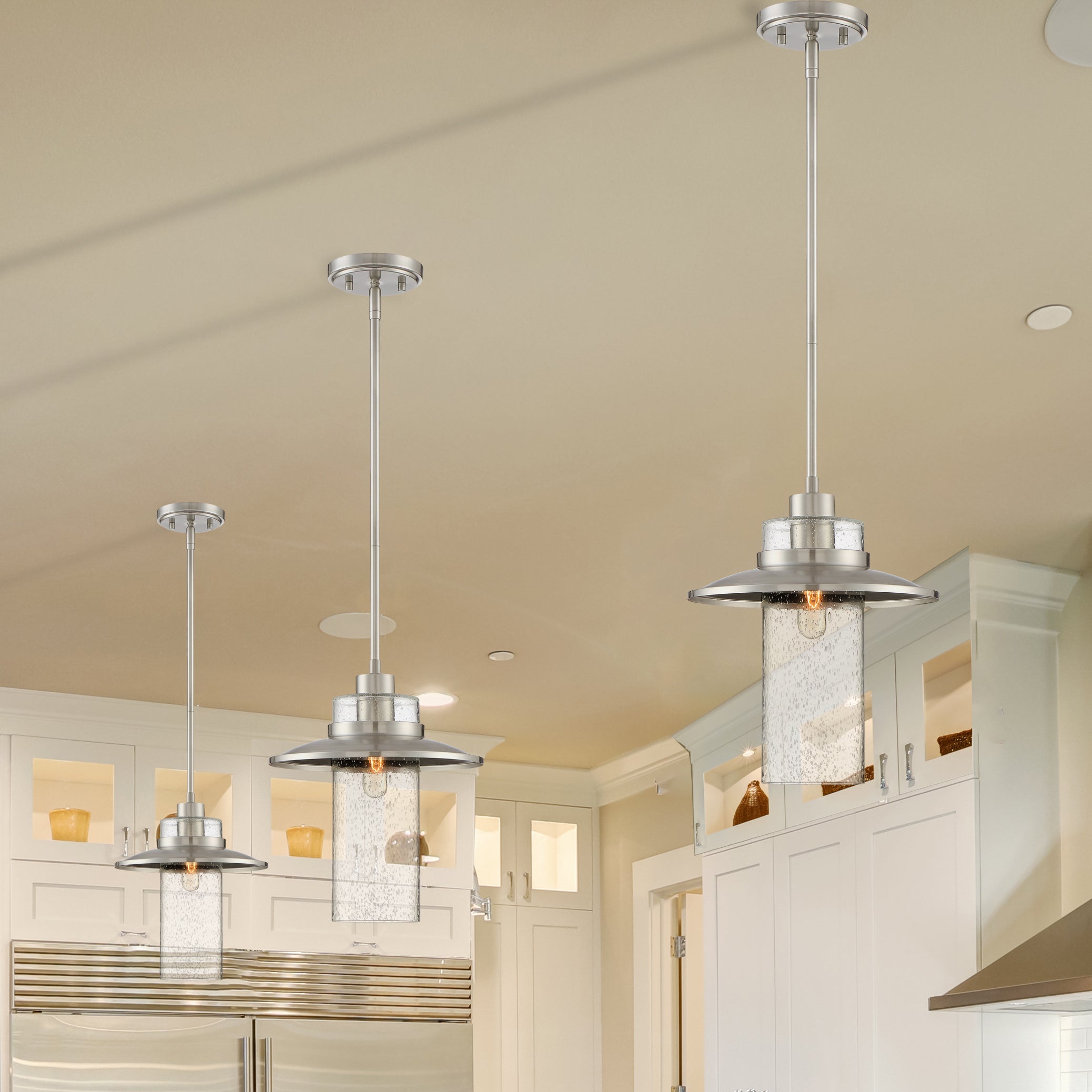 Modern kitchen with pendant lights and stainless steel appliances.
