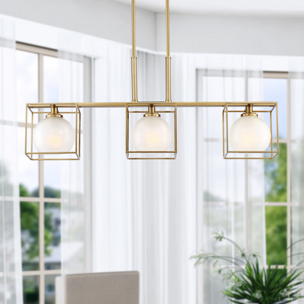 Modern gold pendant light fixture with glass shades in a bright room.