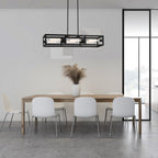 Modern dining area with a long wooden table and white chairs, featuring a pendant light fixture.