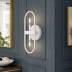 Modern wall sconce on a gray paneled wall with decorative elements.