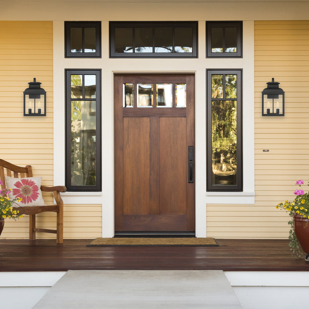 Front door of a house with decorative elements and flowers on a porch