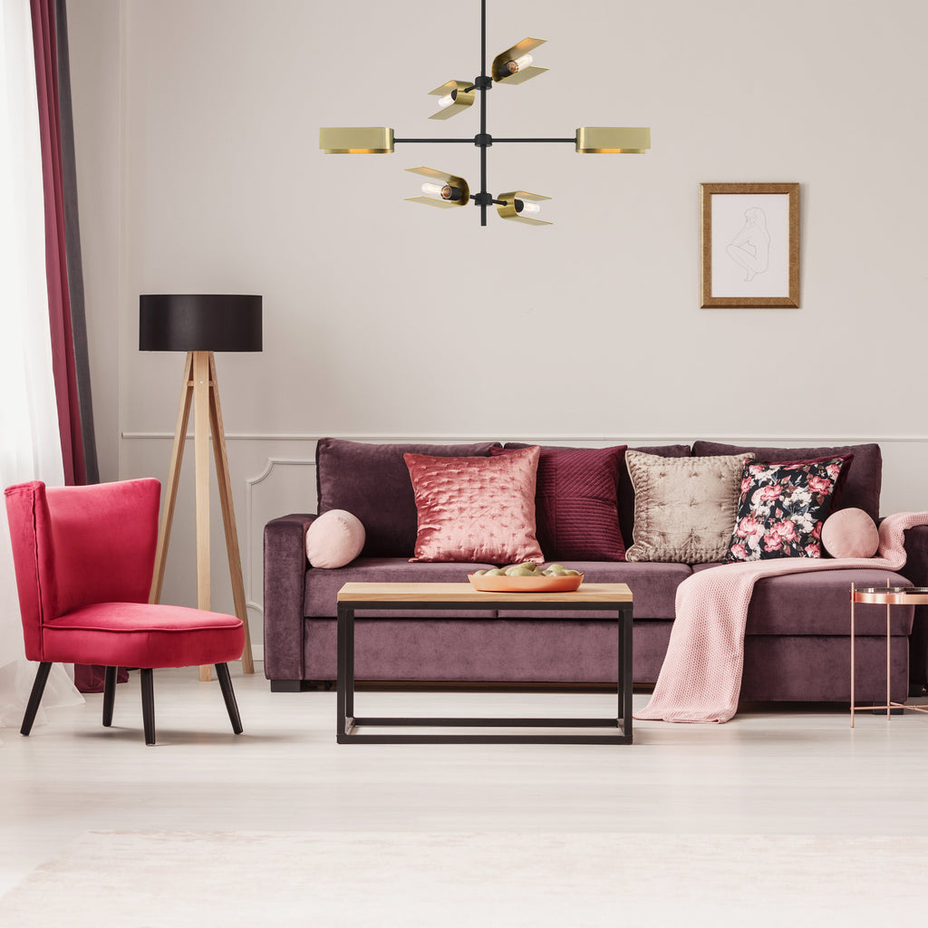 Modern living room with a purple sofa, red armchair, and decorative items.