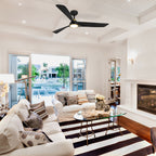 Modern living room with white walls, striped rug, and ceiling fan.