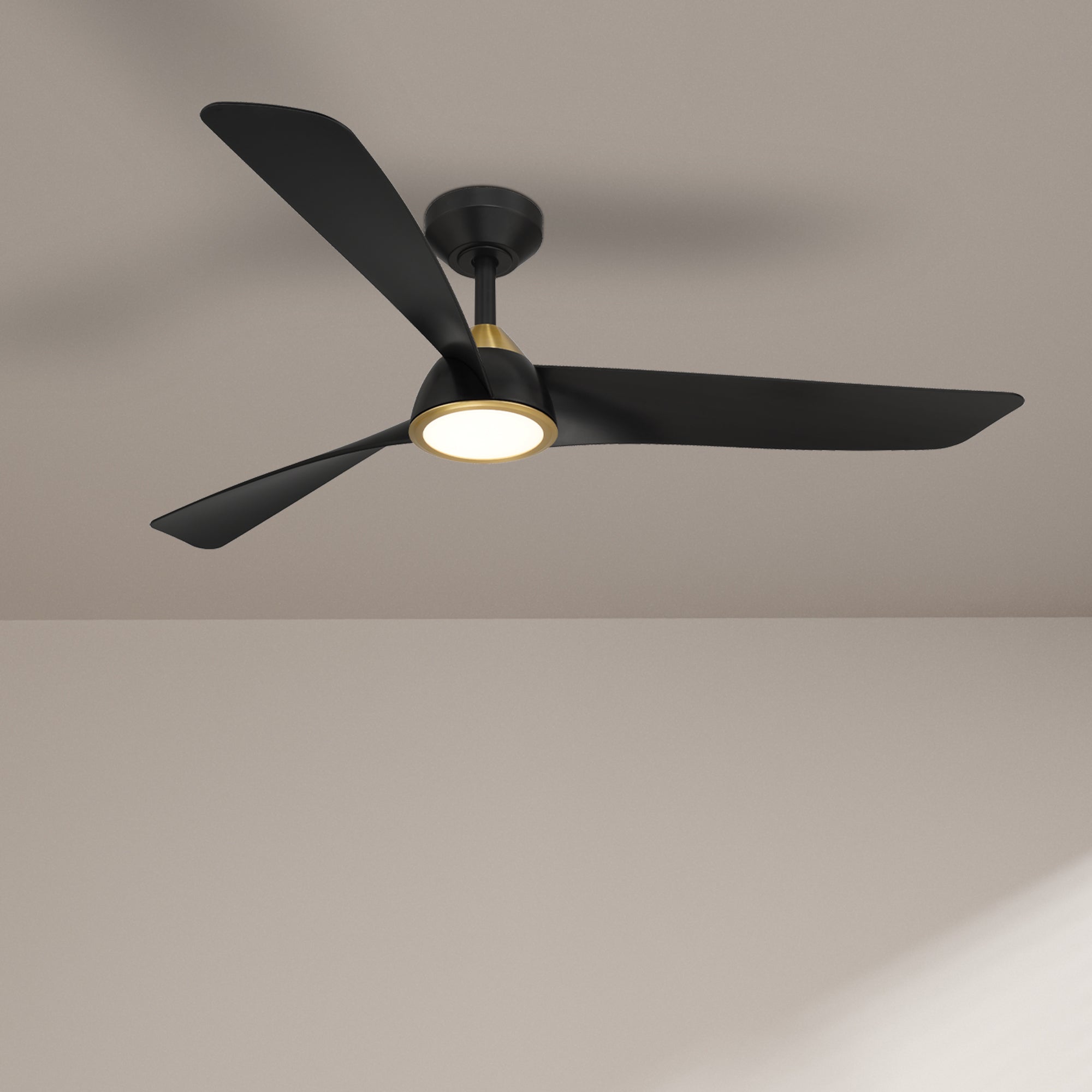 Black ceiling fan with light fixture on a beige wall