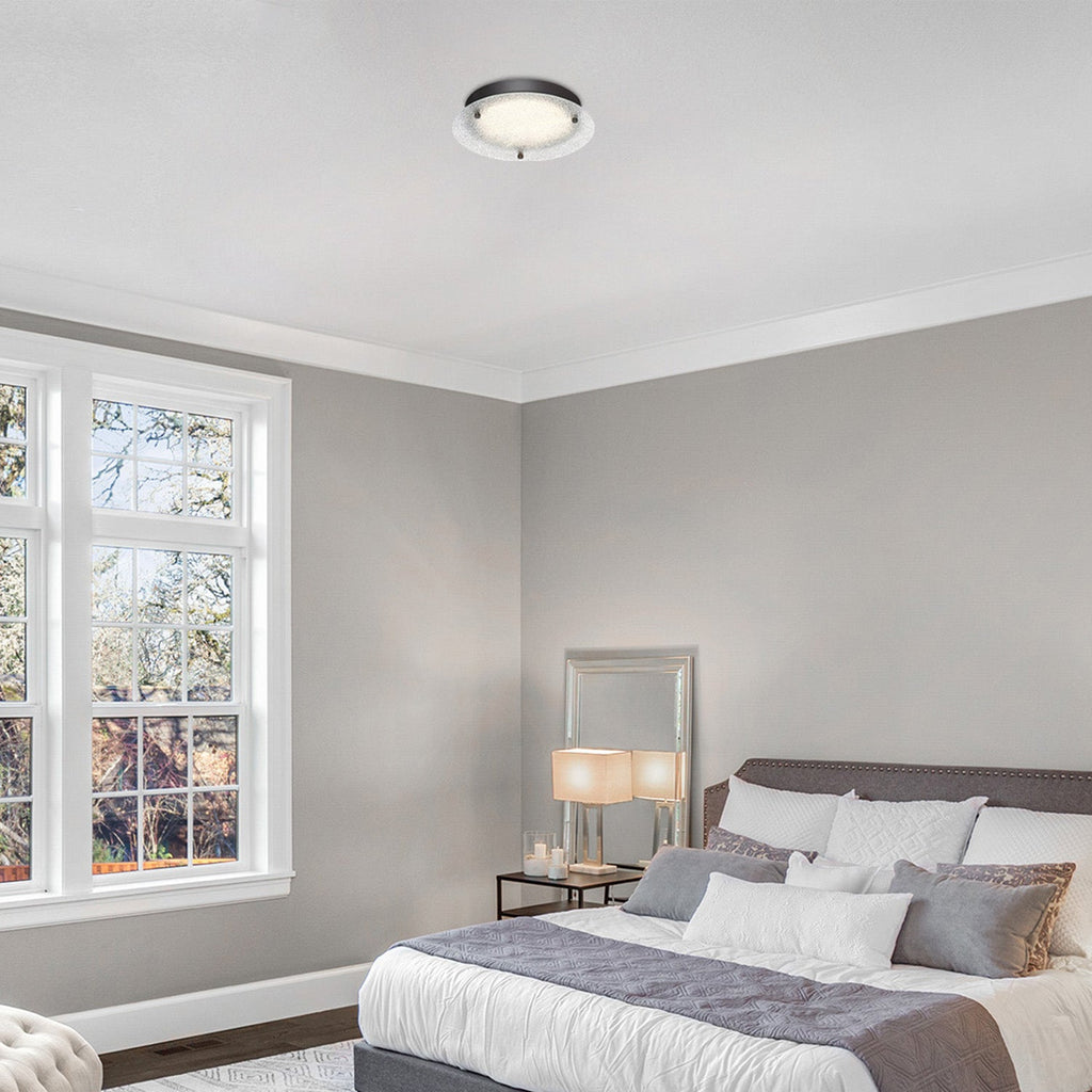 Modern bedroom with gray bed, white walls, and large window.
