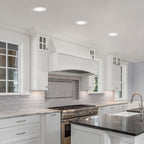 Modern kitchen with white cabinets, granite countertops, and stainless steel appliances.
