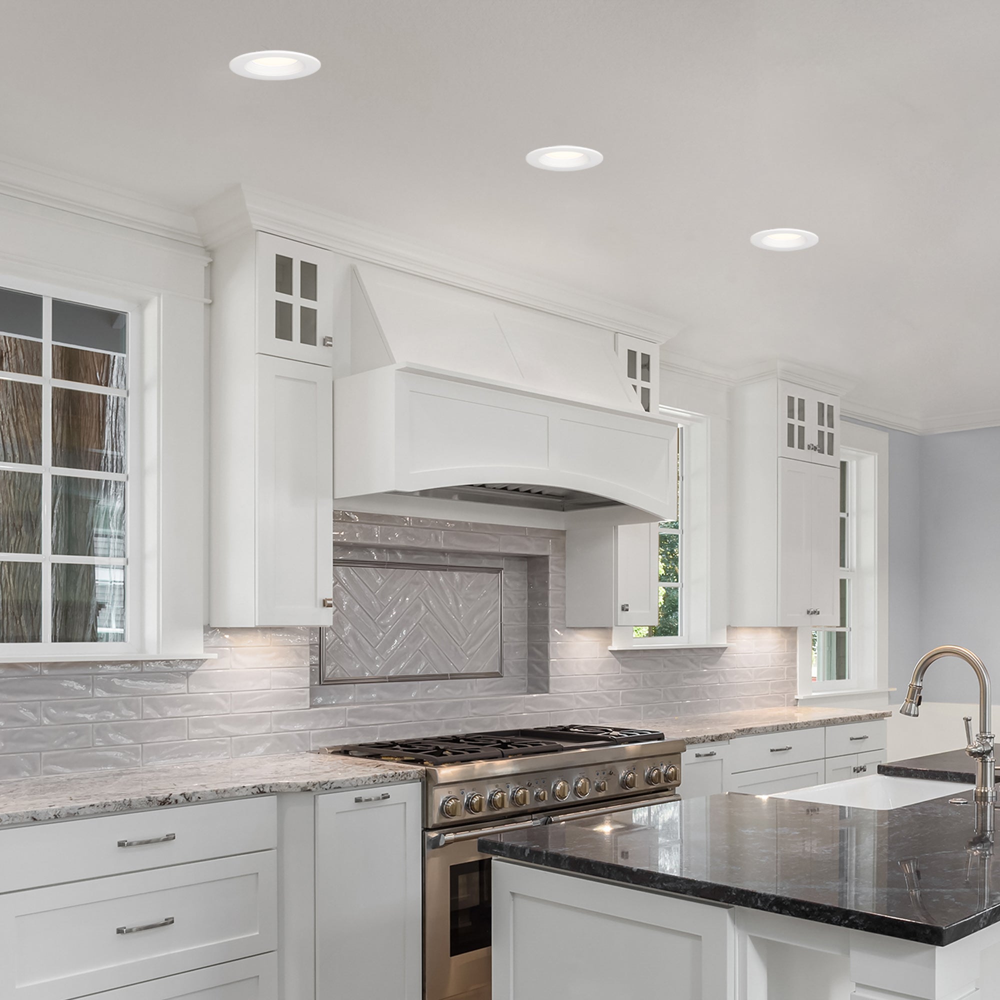 Modern kitchen with white cabinets, granite countertops, and stainless steel appliances.